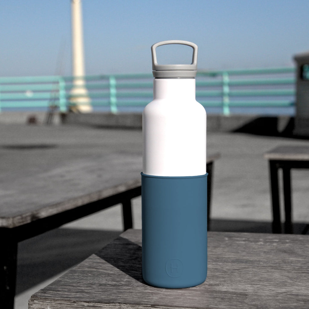 White and navy blue HYDY 20 oz bottle with a sleek design, ideal for hydration on the go.
