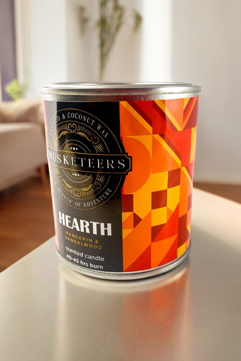 Musketeers Hearth Sandalwood Candle UK with Mandarin and Sandalwood scent, featuring a masculine design and warm lighting.