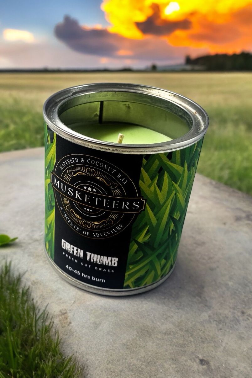 Musketeers grass scented luxury candle with fresh masculine aroma, displayed in a glass holder.