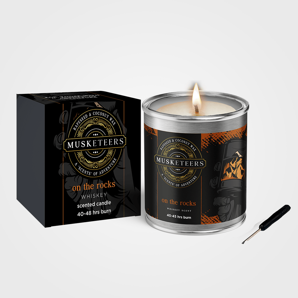 Luxury masculine whisky scented candle by Musketeers, featuring a warm, amber-colored candle in a sleek glass jar.