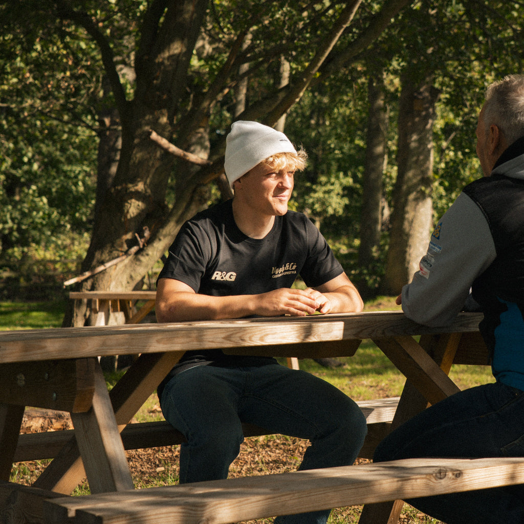 White Uggly and Co beanie worn as a stylish accessory, featuring a cozy knit design perfect for cold weather.