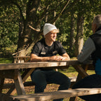 White Uggly and Co beanie worn as a stylish accessory, featuring a cozy knit design perfect for cold weather.