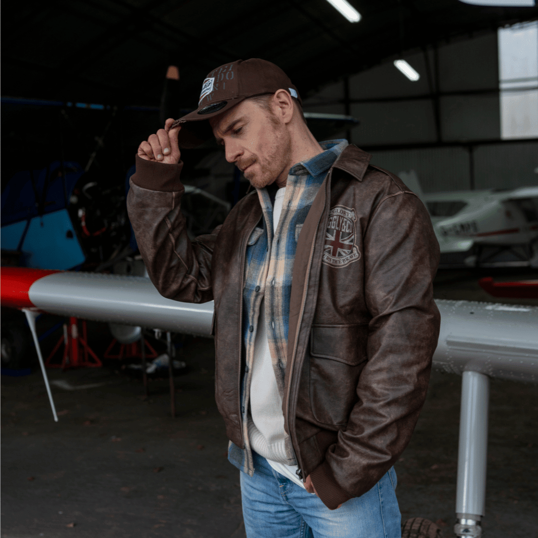 Brown Uggly and Co Aviation Diamond Trucker Hat featuring a baseball cap style with embroidered diamond logo and adjustable mesh back.
