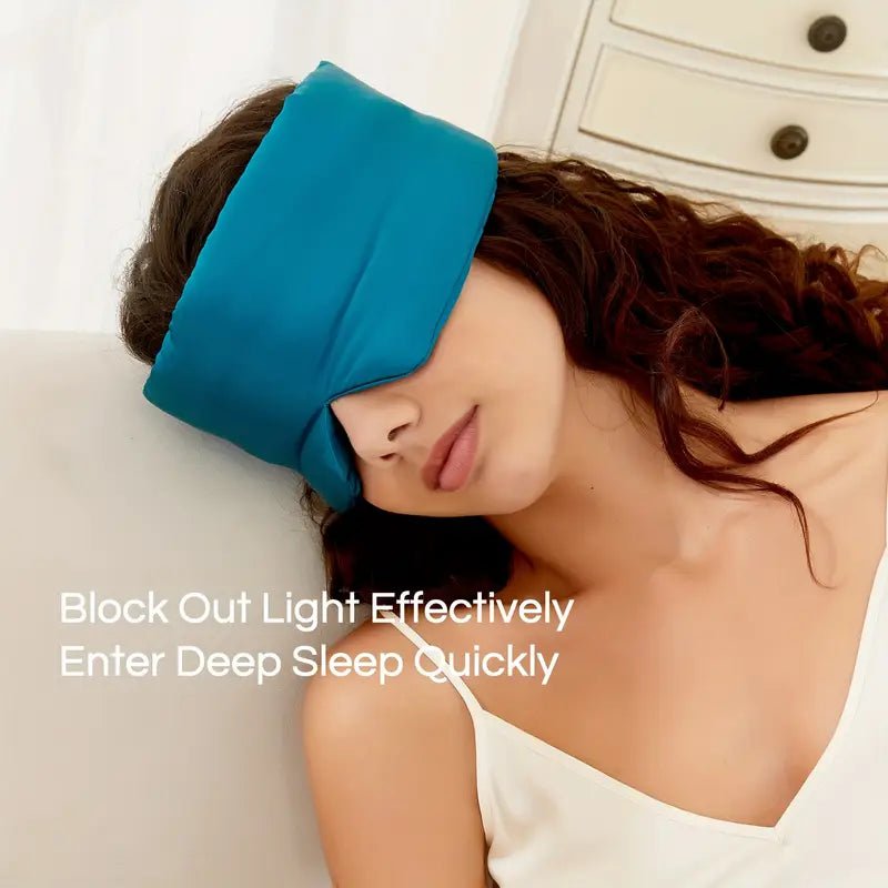 Black silk sleep mask by DREAMSILK, featuring a smooth, luxurious fabric designed to block out light and improve sleep.