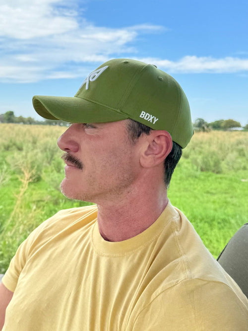 Oregon green BDXY Studios "The Focus" baseball cap with curved brim and adjustable strap, shown from front view.