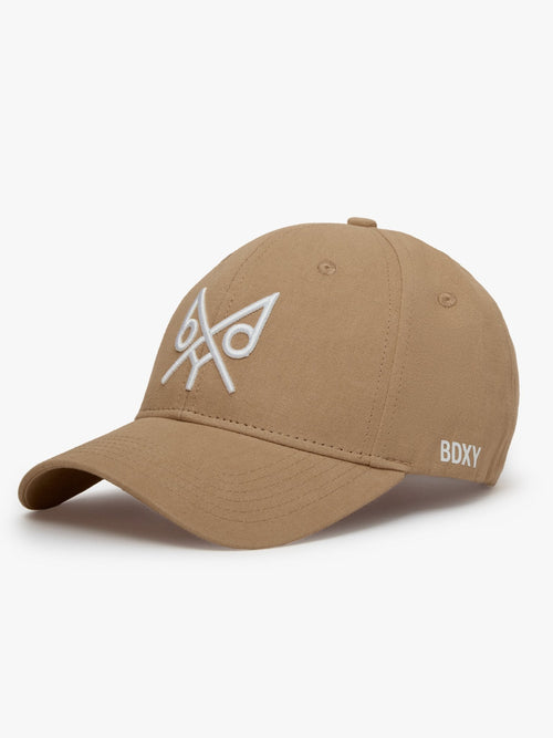Tan "The Focus" baseball cap by BDXY Studios, showing front view with adjustable strap and curved brim.