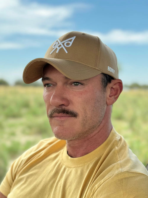 Tan baseball cap from BDXY Studios titled "The Focus" with a curved brim and adjustable strap, shown from the front.