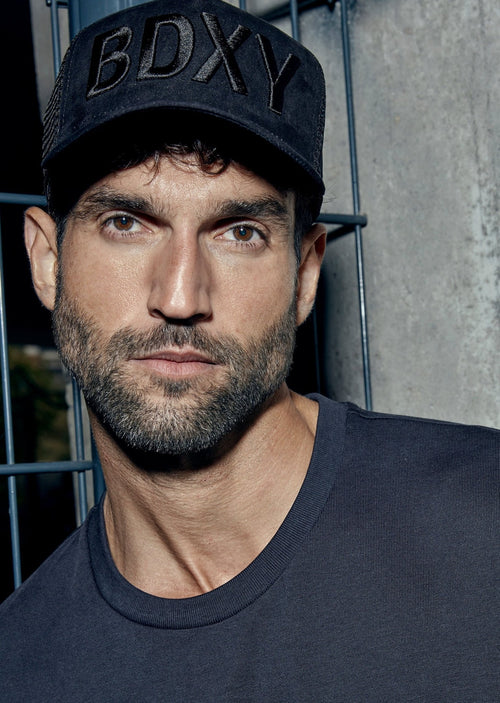 Black "The Gaffer" trucker cap by BDXY Studios featuring a mesh back and curved brim.