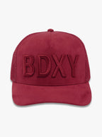 Burgundy "The Gaffer" trucker cap by BDXY Studios featuring a mesh back and adjustable strap, casual headwear for everyday wear.