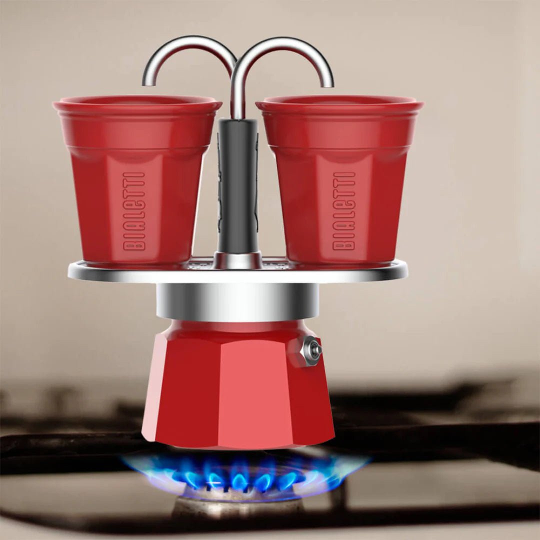 Red Bialetti Mini Express 'R' double serve coffee maker by Brew Italia, featuring two cups and a compact Italian design.