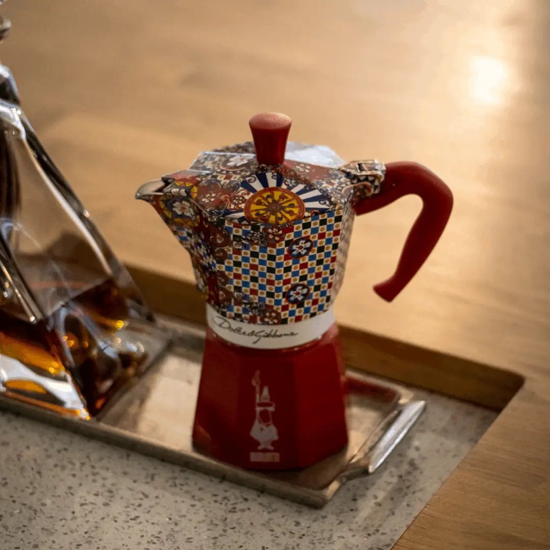 Bialetti X Dolce&Gabbana Sicilian Cart Moka Express coffee maker with colorful floral and Sicilian-inspired design, stainless steel body.