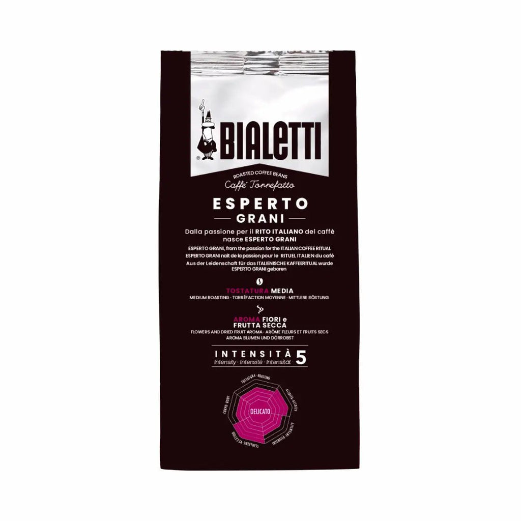 Bialetti Brew Italia Delicato whole bean coffee with light brown beans in a clear glass jar on a white background.