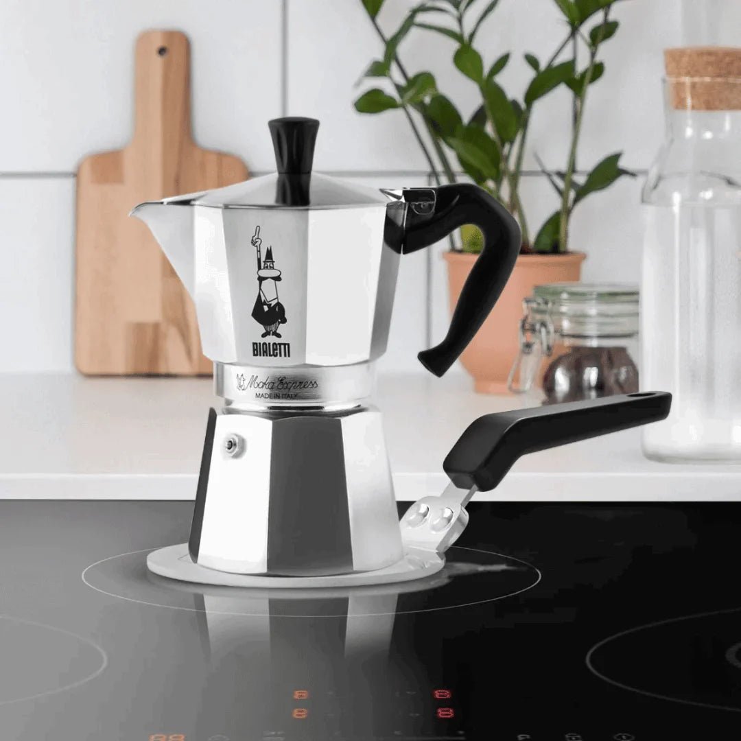 Bialetti Brew Italia induction plate, compact stovetop accessory for brewing coffee, with a sleek black design and Bialetti branding