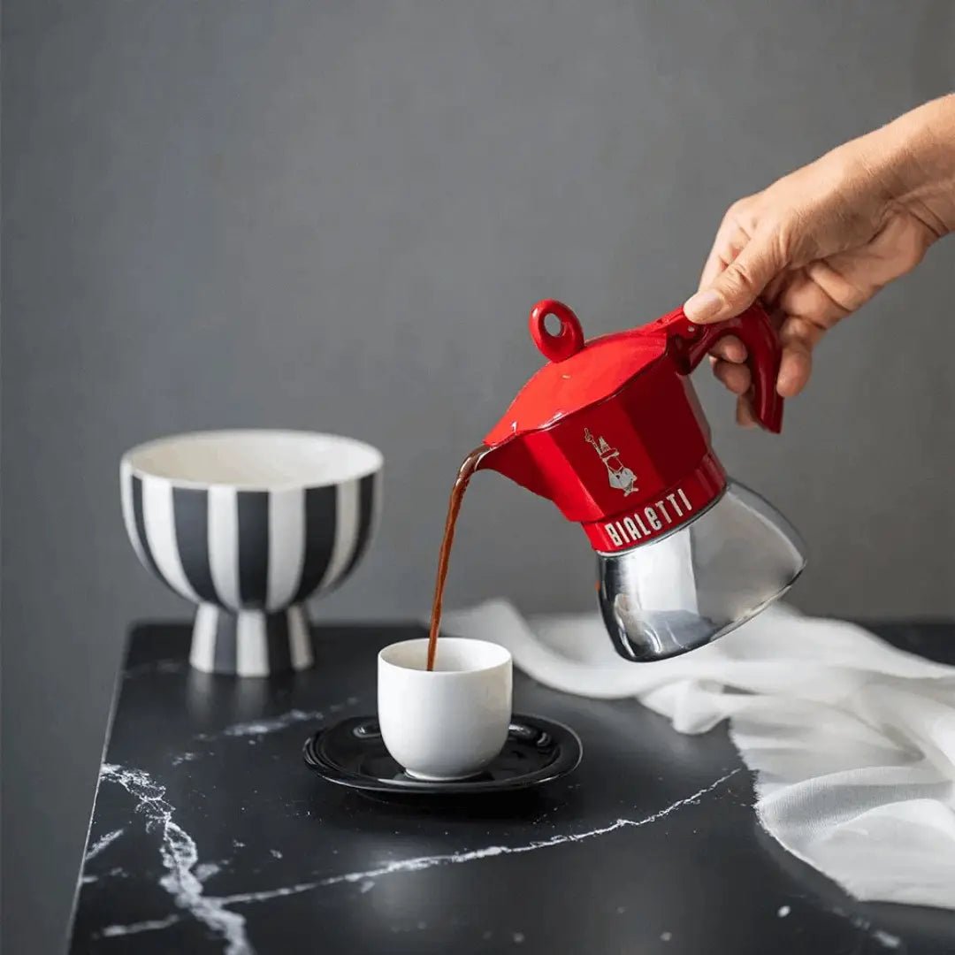Bialetti Moka Induction Exclusive coffee maker by Brew Italia, stainless steel with black handle and lid for induction stovetops.