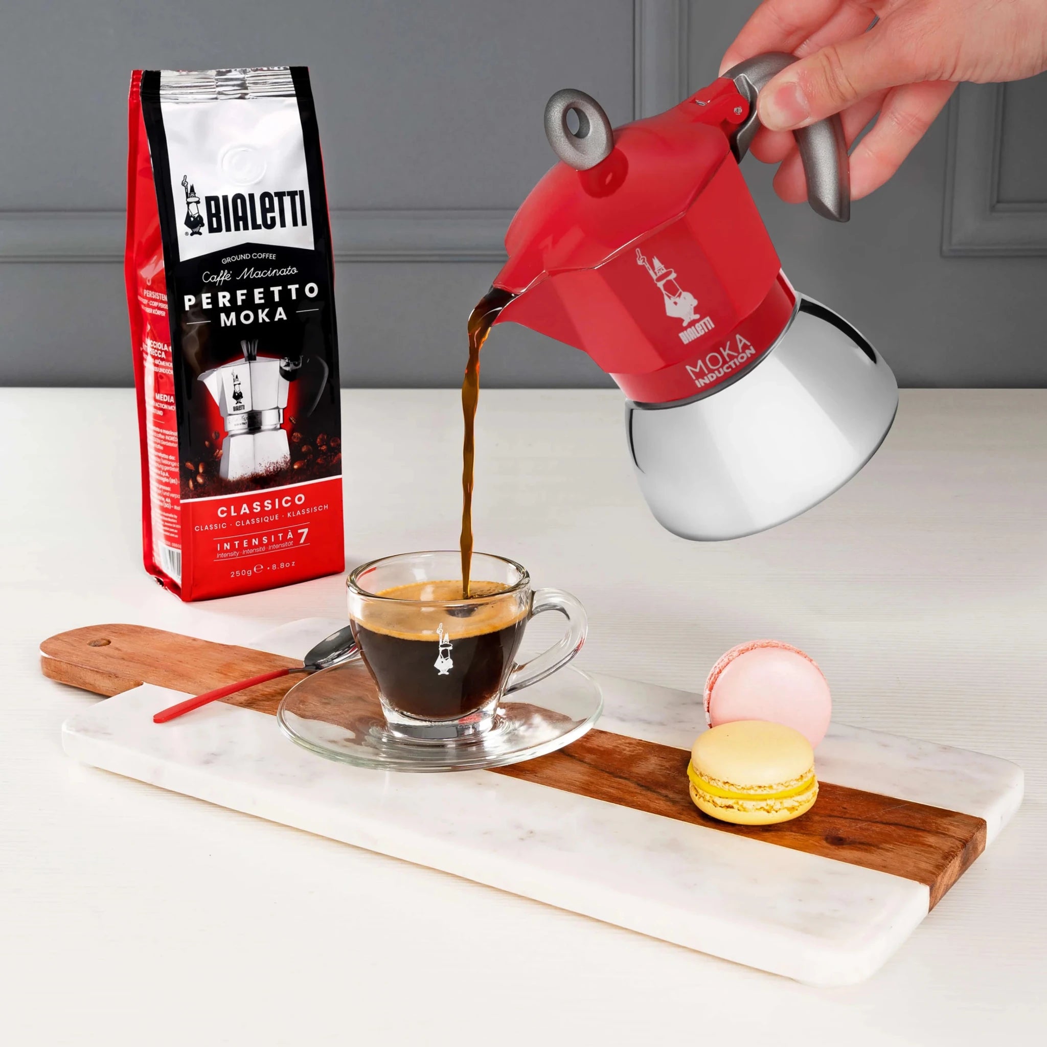 Red Bialetti Moka induction stovetop coffee maker by Brew Italia with a sleek design and compact size.