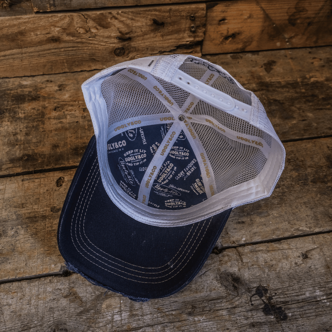 Night blue and gold diamond Uggly and Co trucker cap with mesh back and curved brim, stylish biker-inspired headwear.