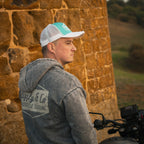 Turquoise and white diamond trucker cap by Uggly and Co featuring a classic biker-style design and adjustable mesh back.