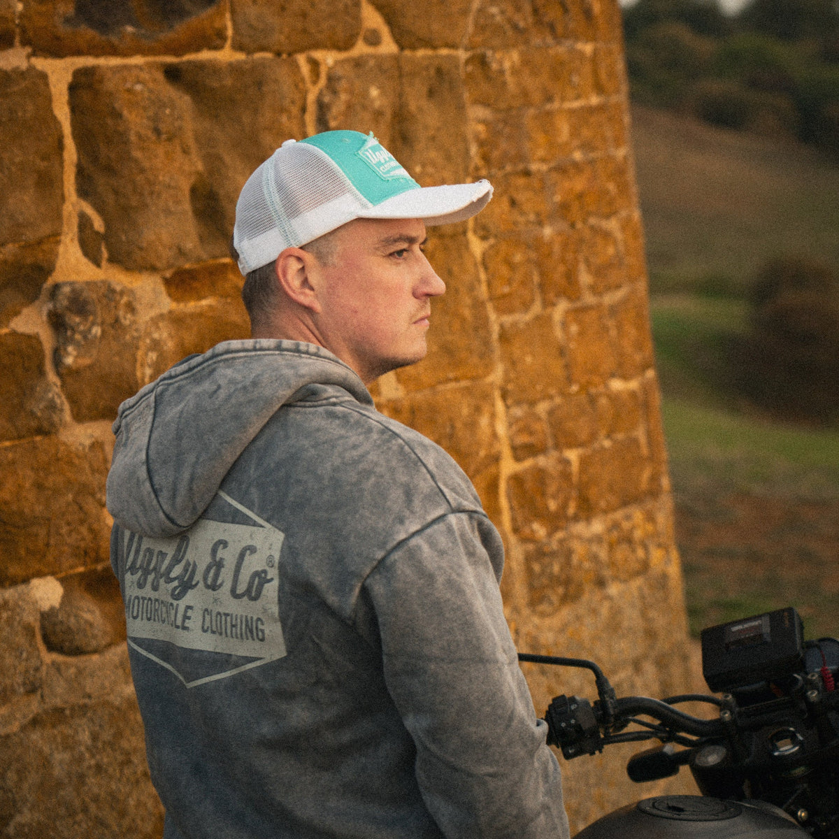 Turquoise and white diamond trucker cap by Uggly and Co featuring a classic biker-style design and adjustable mesh back.