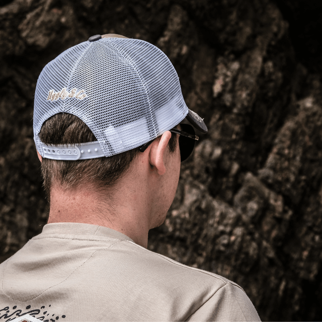 Beige surf diamond trucker cap by Uggly and Co with mesh back and curved brim, casual outdoor accessory.
