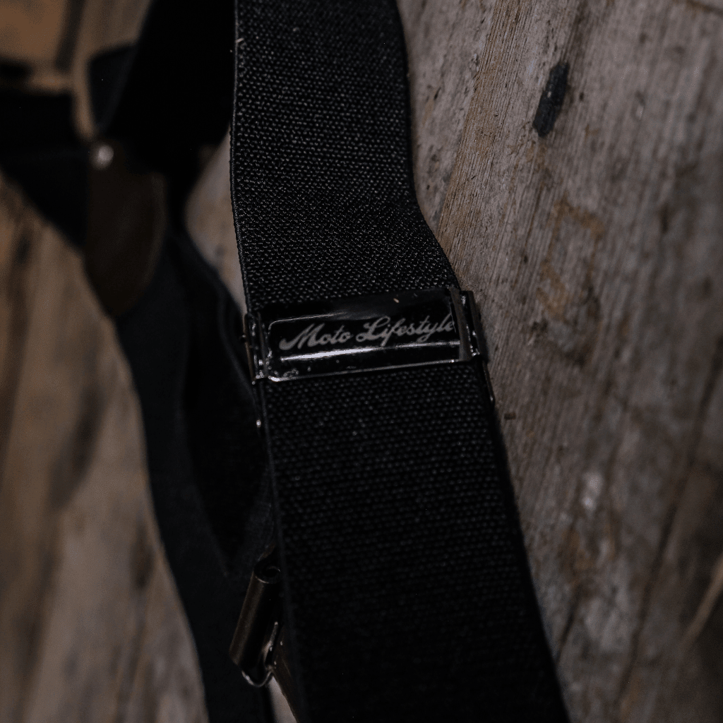 Black utility braces by Uggly and Co featuring adjustable straps and metal clasps, designed as versatile accessories.