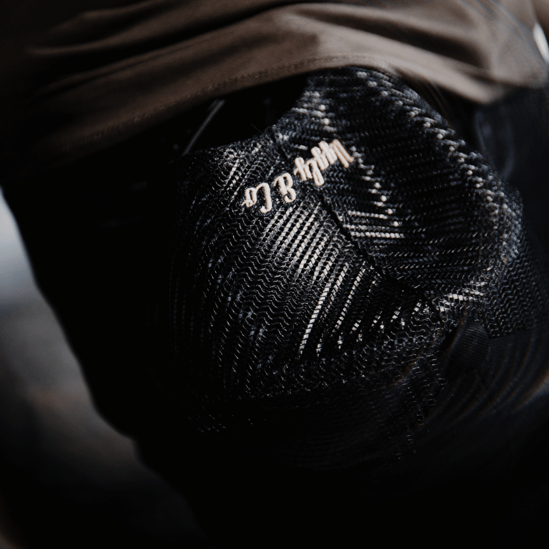 Black flat track trucker hat by Uggly and Co featuring a classic bikerwear design with mesh back and curved brim.