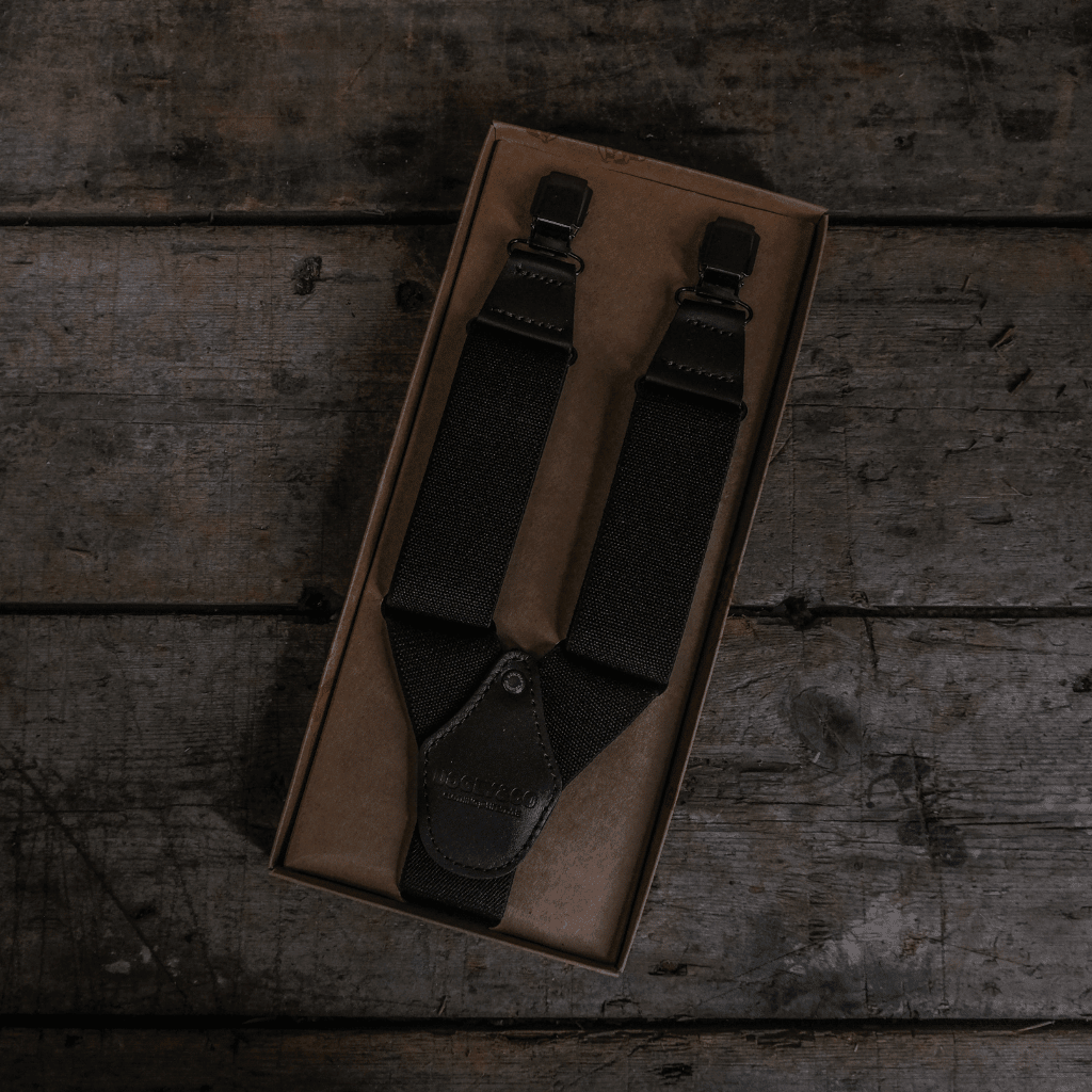 Black utility braces from Uggly and Co, featuring durable straps and metal buckle closures, designed for motorcycle accessories.