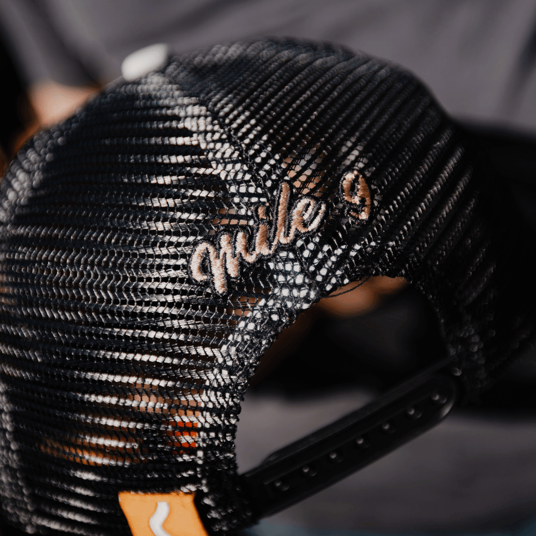 Black trucker cap with "09" Stone Parts & Spares logo, Uggly and Co brand, adjustable mesh back, casual style.