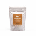 Ground heavy bourbon coffee from Jittr Coffee Co in a 250g bag, showcasing rich, dark roasted beans.