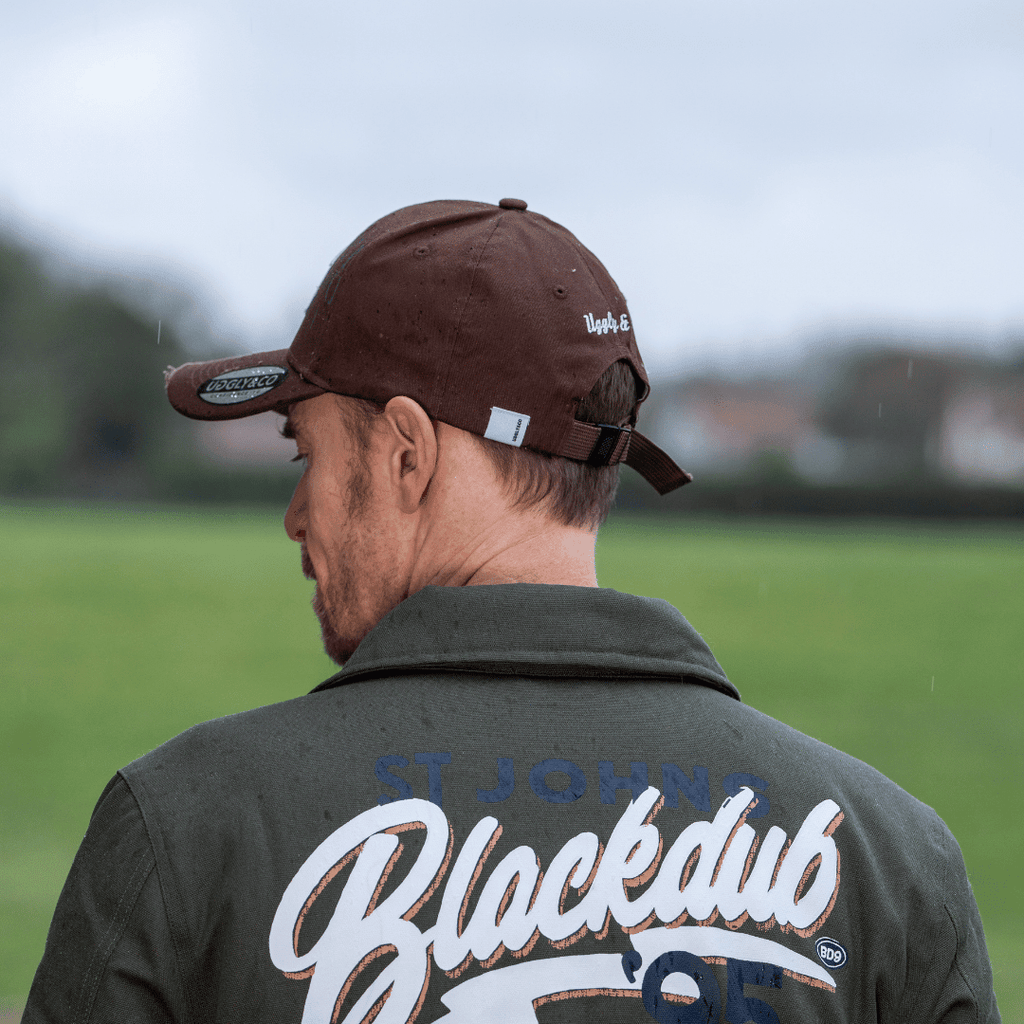 Brown Uggly and Co aviation diamond trucker hat with British heritage motorcycle-themed design, casual baseball cap style.