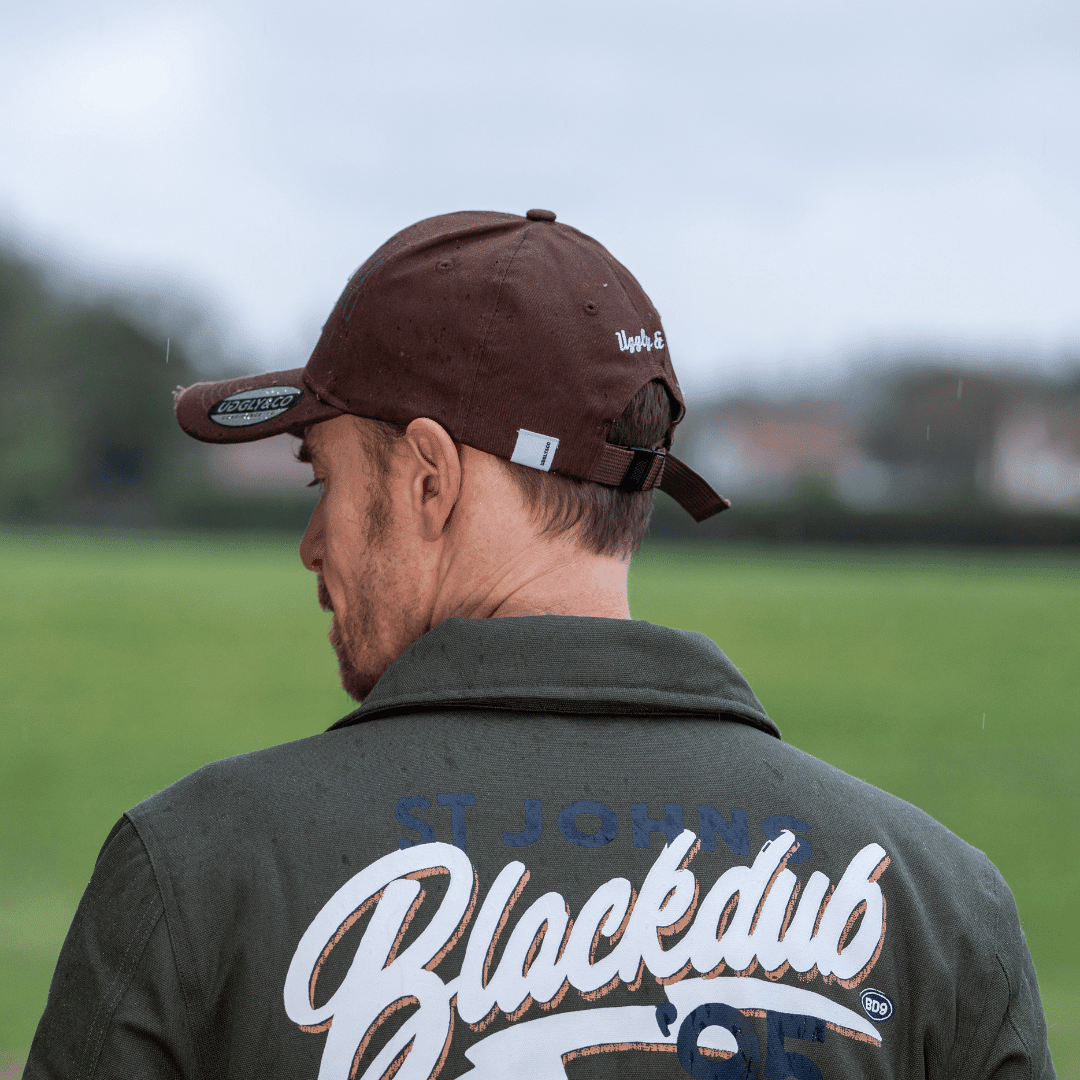 Brown Uggly and Co aviation diamond trucker hat with British heritage motorcycle-themed design, casual baseball cap style.
