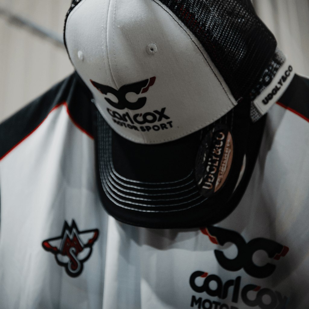 Uggly and Co Carl Cox Icon Trucker Hat featuring a classic trucker cap style with DJ-inspired design and branding.
