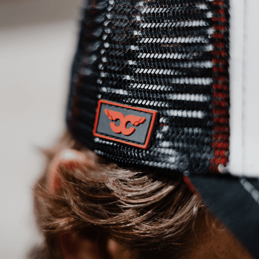 Carl Cox Icon trucker hat by Uggly and Co featuring a curved brim, mesh back, and bold logo design.