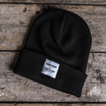 Uggly and Co Carl Cox Icon Beanie showing a black knit beanie with a bold logo design for motorsport enthusiasts.
