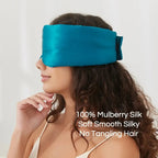 Black silk sleep mask by DREAMSILK with adjustable strap and smooth, shiny fabric for complete blackout and restful sleep.