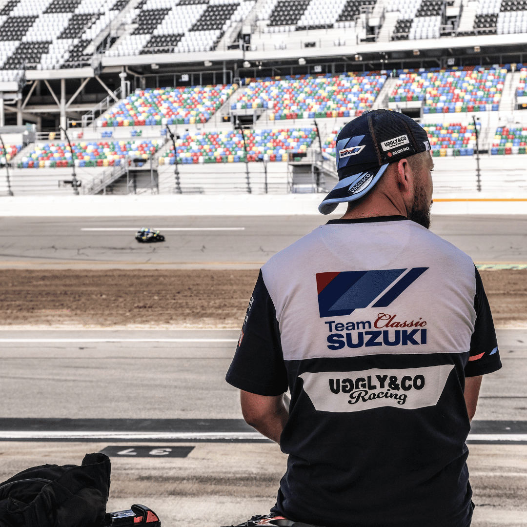 Uggly and Co Team Classic Suzuki motorcycle trucker hat with front logo, adjustable mesh back, and curved brim.