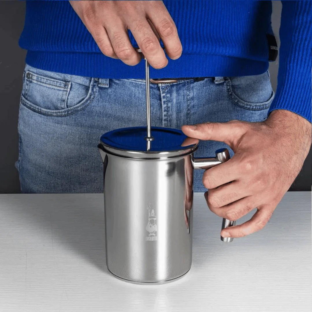 Bialetti Brew Italia manual milk frother with stainless steel body and handle for creating creamy frothed milk.