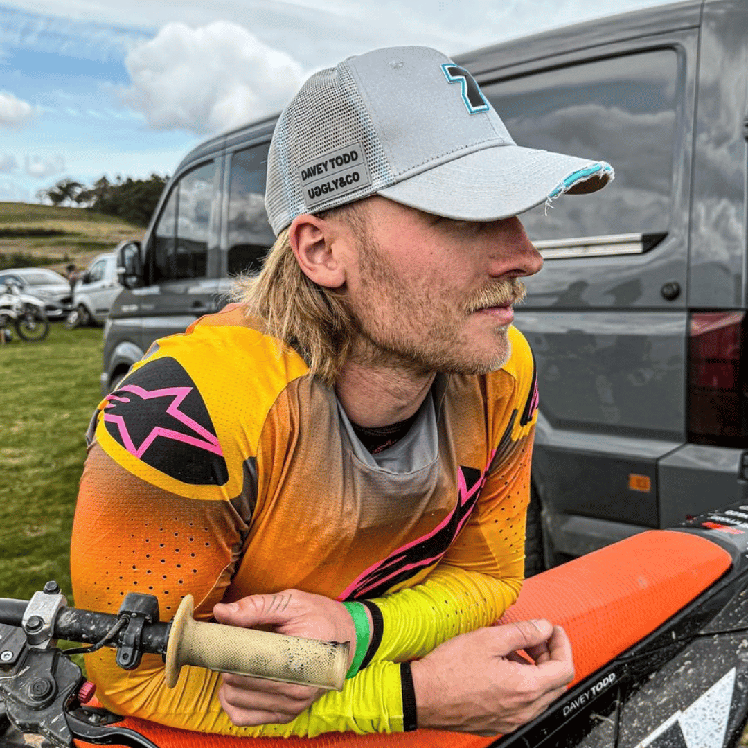 Steel grey Uggly and Co trucker cap featuring Davey Todd racing graphic for a stylish, casual look.
