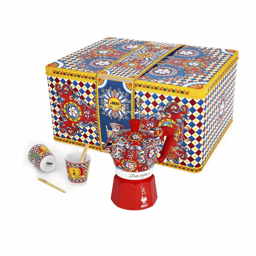 Bialetti X Dolce&Gabbana Sicilian Cart gift set with 2-cup moka, 2 cups, and gold stirrers, featuring festive design and branding.