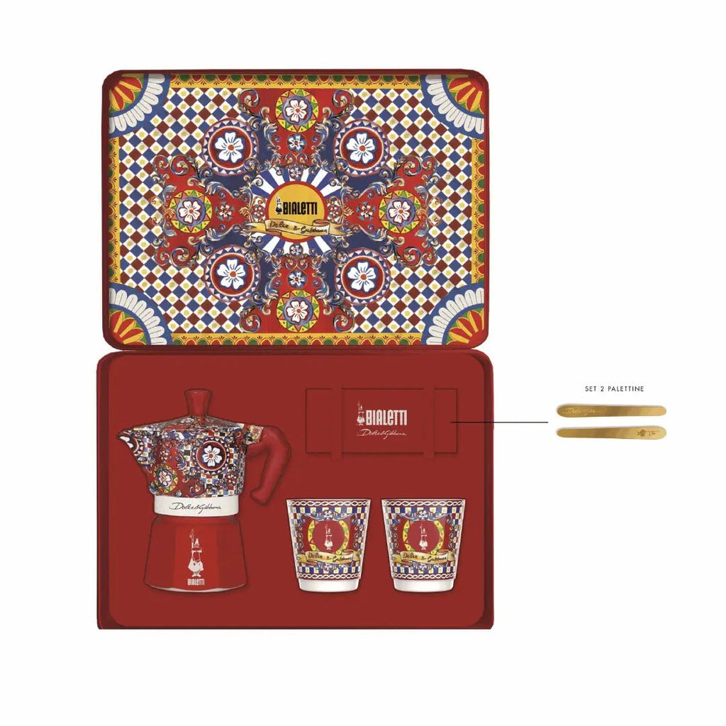 Bialetti Brew Italia Dolce&Gabbana Sicilian Cart gift set with 2-cup moka pot, 2 cups, and gold stirrers on holiday-themed packaging