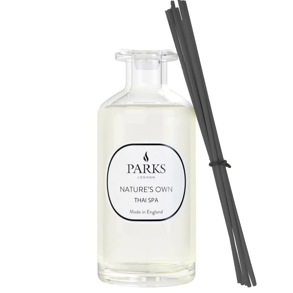 Thai Spa Reed Diffuser by Parks Candles in a 100ml glass bottle with natural reed sticks, designed to infuse a calming aroma.