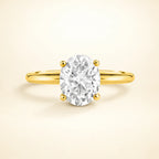 Vianne Jewellery 2 ct oval solitaire moissanite engagement ring in 18k gold vermeil displayed on a warm studio backdrop.