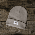 Grey oatmeal beanie by Uggly and Co, soft knit winter hat with a cozy, casual style shown on a model.