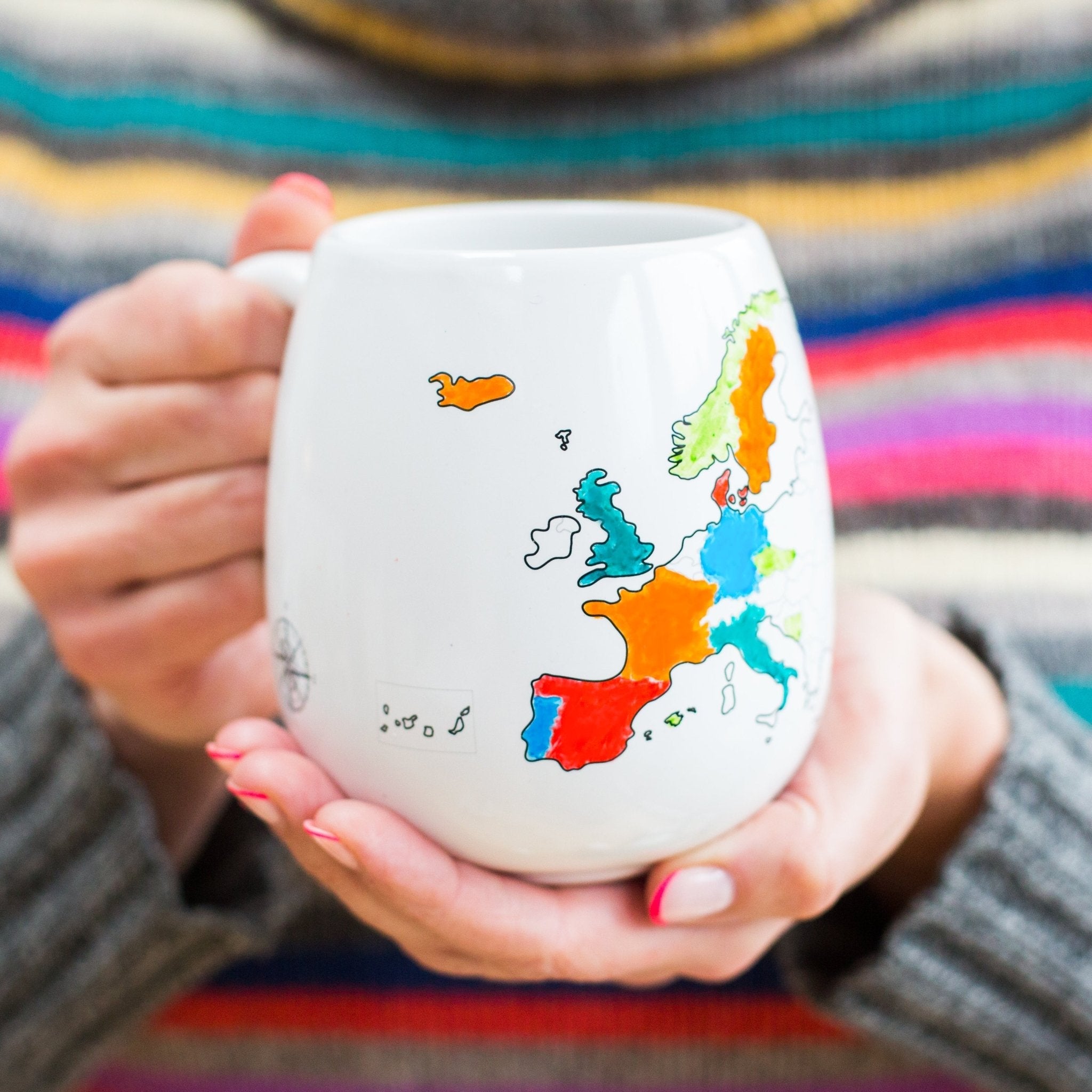 Trouvaille Europe map color-in travel mug held in hand, featuring a detailed map design for coloring.