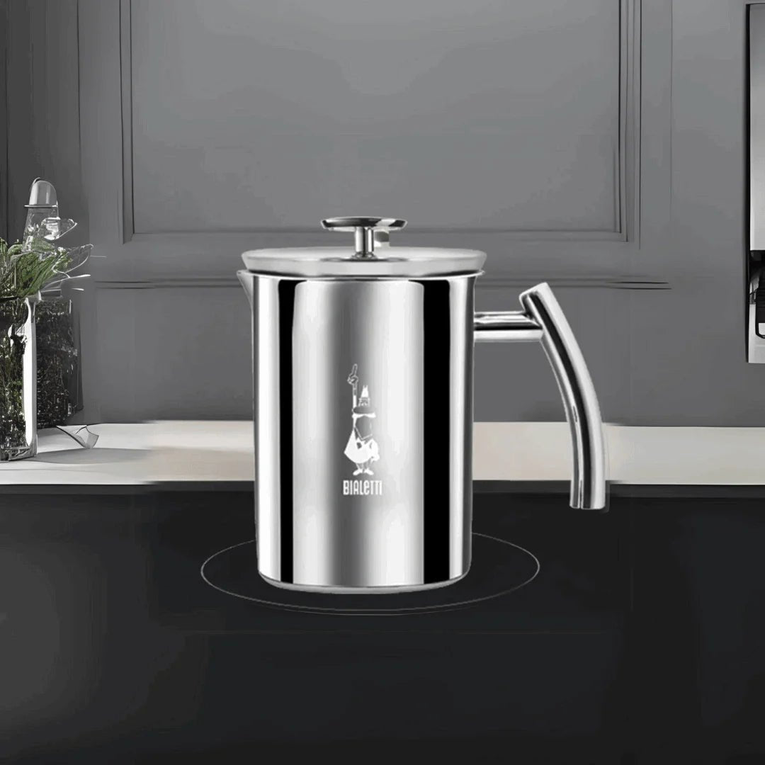 Bialetti Brew Italia manual milk frother on induction hob, stainless steel with handle for frothing milk.