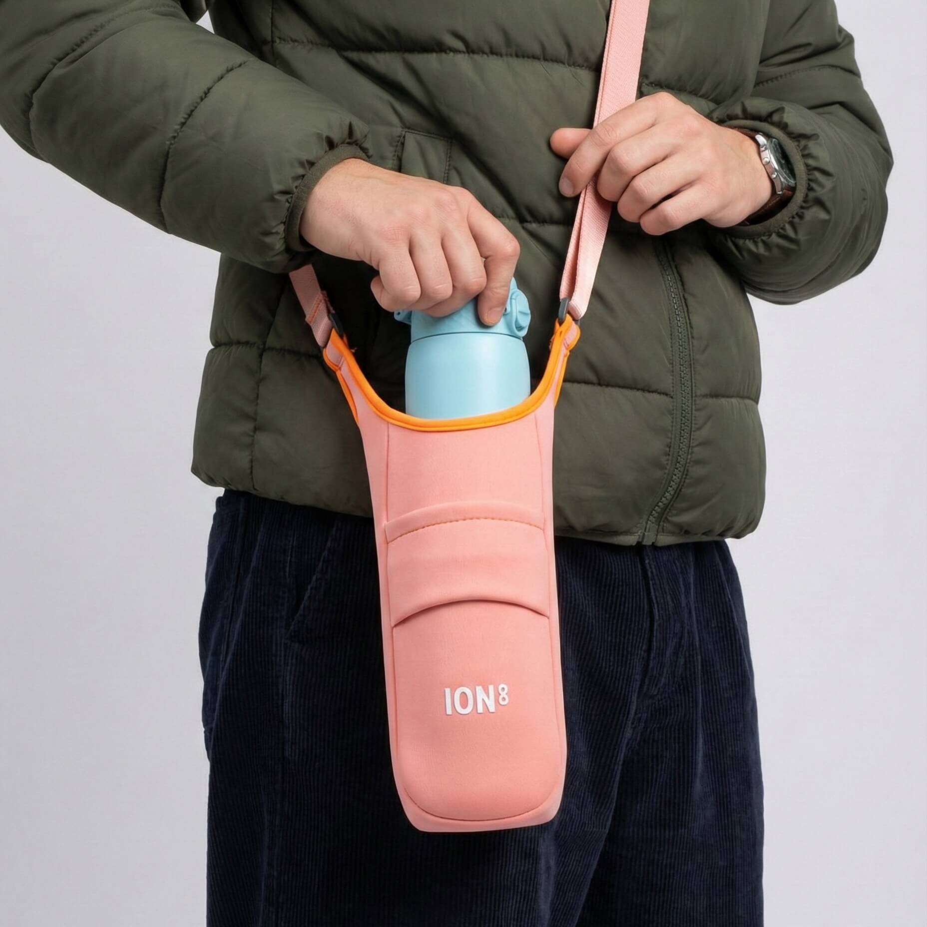Coral lightweight sling bottle bag by ION8, featuring a compact design with adjustable strap and secure bottle compartment.
