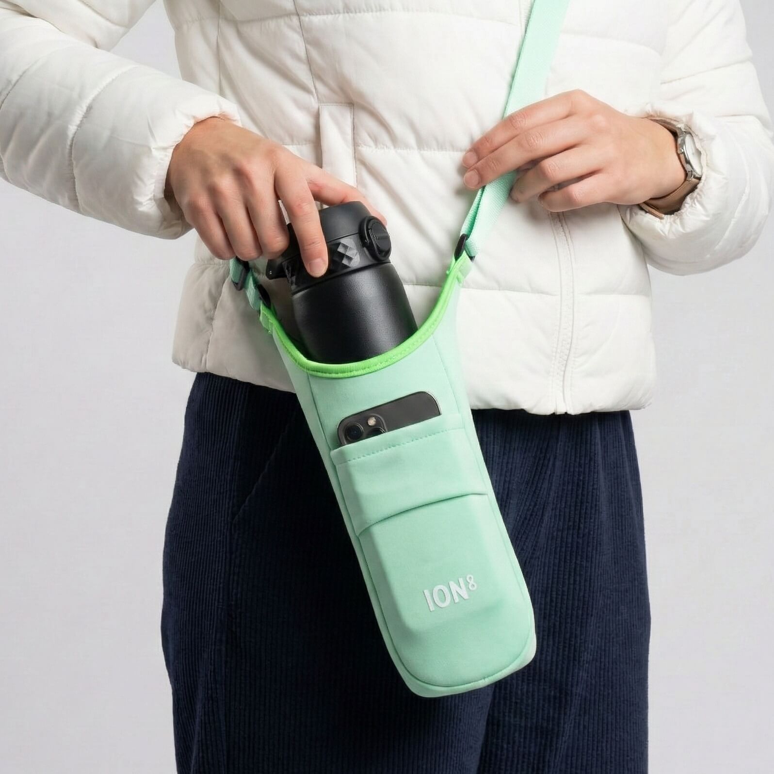 Green ION8 sling bottle bag from Xtras & Add-Ons collection, lightweight and compact for carrying beverages easily.