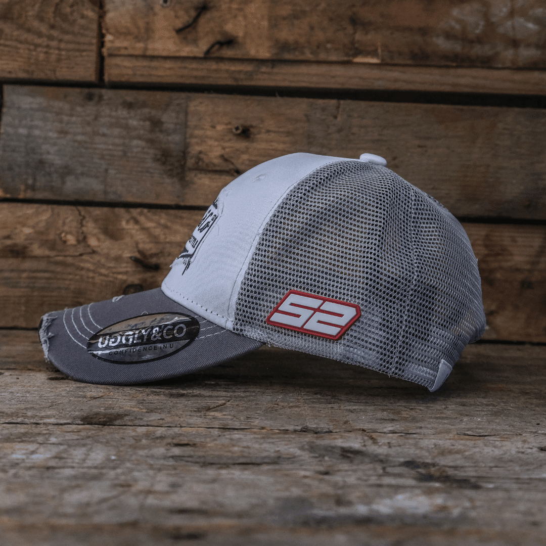 Grey and white diamond-patterned trucker cap by Uggly and Co featuring a classic mesh back and curved brim.