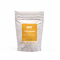 Fresh ripe mangoes in a basket for Fruity Mango coffee by Jittr Coffee Co, showcasing the tropical fruit flavor.