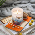 Trouvaille Marine Soy Scented Candle with fresh bergamot and vetiver, showcasing a sleek candle container with a burning flame.