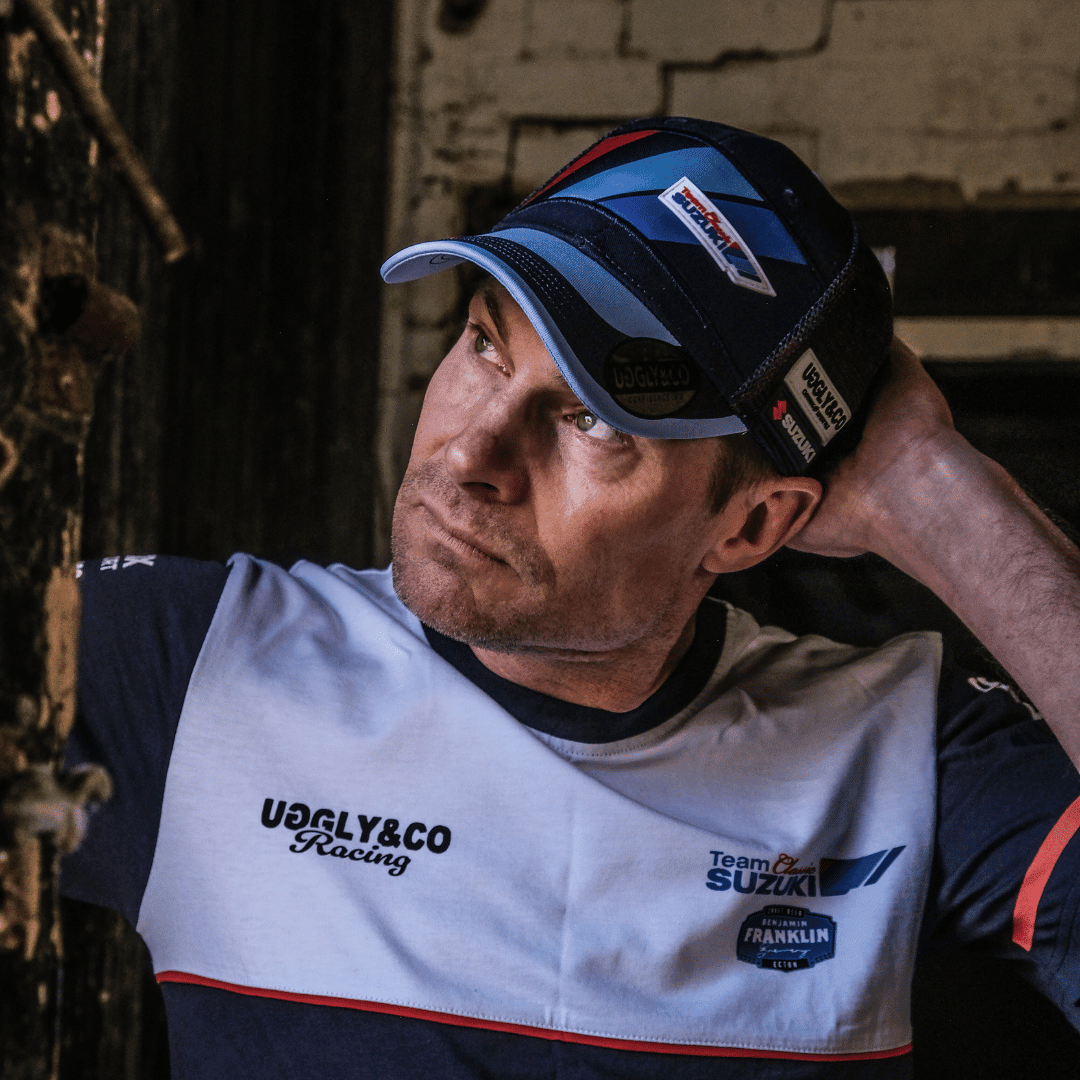 Men's Suzuki Trucker Cap by Uggly and Co featuring classic biker style with adjustable mesh back and embroidered Suzuki logo.